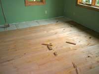 Alder flooring being installed in the guest bedroom